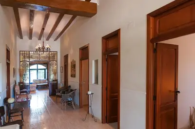 a hallway with wooden doors and a living room at Villamilagro in Sueca