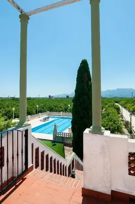 a view from the balcony of a house with a swimming pool at Villamilagro in Sueca