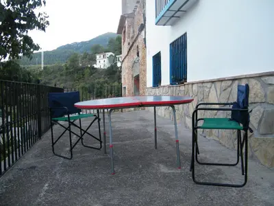 two chairs and a table and a table and chairs at Casa La Chelva in Alcudia de Veo
