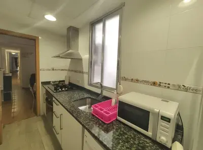 a kitchen with a sink and a microwave on a counter at Apartamento La Marina Real in Valencia