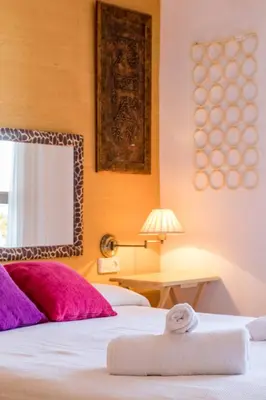 a hotel room with two beds with purple pillows at Apartamento Calipso in El Palmar