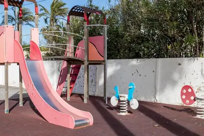 a playground with a slide and a slideintend at Apartamento Calipso in El Palmar