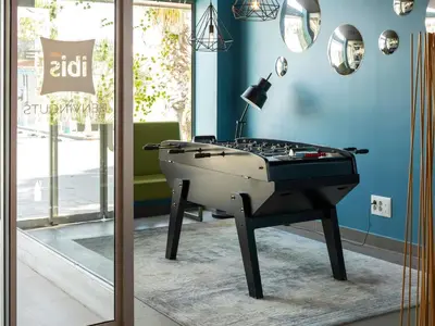 a ping pong table sitting in a room with ahibition at Ibis Valencia Bonaire Aeropuerto in Aldaya
