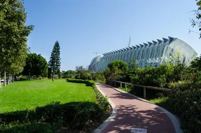 a walkway through a park with a building in the background at ApartUP Francia Views in Valencia