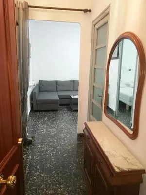 a living room with a couch and a mirror at Apartamento Cuatro Carreres in Valencia
