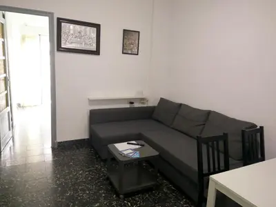 a living room with a couch and a table at Apartamento Cuatro Carreres in Valencia