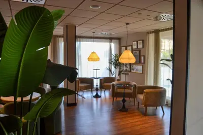 a living room with chairs and a table in a room at Sweet Hotel Renasa in Valencia