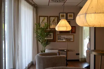 a living room with two chairs and a lamp at Sweet Hotel Renasa in Valencia