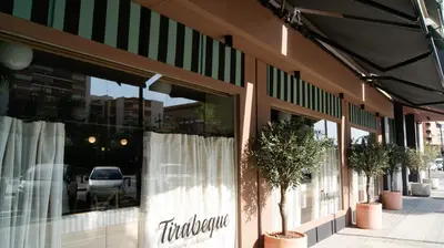a store front with white curtains and potted trees at Sweet Hotel Renasa in Valencia