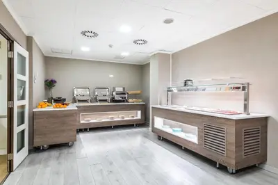 a restaurant with a counter with food on it at Sweet Hotel Renasa in Valencia