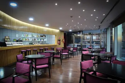 a dining room with tables and purple chairs at Senator Parque Central in Valencia
