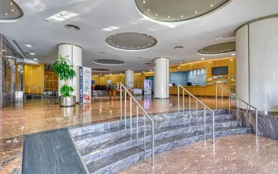 a lobby with a staircase in a building at Senator Parque Central in Valencia