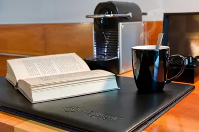 a black tray with a book and a cup and a coffee mug at Senator Parque Central in Valencia