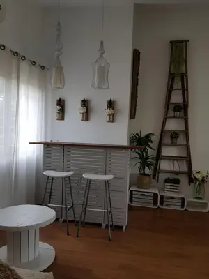 a kitchen with two stools and a bar in a room at Domus Valencia Apartamentos Casa con piscina privada a 30 minutos de Valencia in Turís