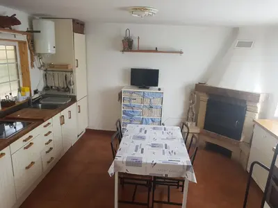 a kitchen with a table with papers on it at Domus Valencia Apartamentos Casa con piscina privada a 30 minutos de Valencia in Turís