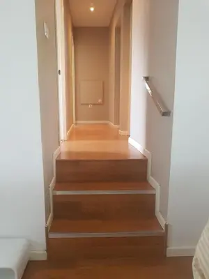 a hallway with a staircase with wood floors at Domus Valencia Apartamentos Casa con piscina privada a 30 minutos de Valencia in Turís