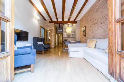 a bedroom with a bed and a painting on the wall at La Casa Chica del Carmen in Valencia