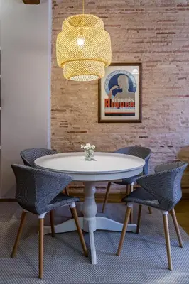 a dining room table with chairs and a chandelier at La Casa Chica del Carmen in Valencia