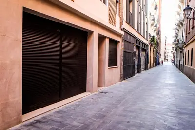 an empty alley with closed garage doors on a building at Apartment Triador in Valencia