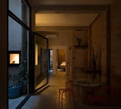 a living room with a table and a dining room at Beach loft in Valencia