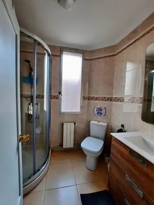 a bathroom with a toilet and a shower and a sink at Piso en la playa in Valencia