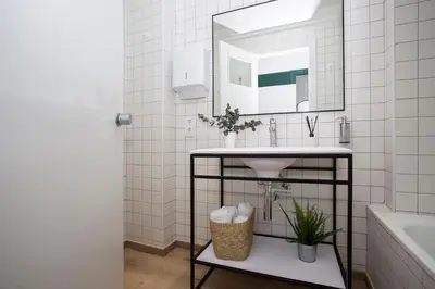 a bathroom with a sink and a mirror at Palacios Rooms in Valencia