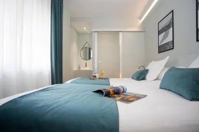 a bedroom with two beds with blue and white at Palacios Rooms in Valencia