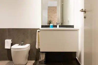 a bathroom with a toilet and a sink at Mon Suites San Martin in Valencia