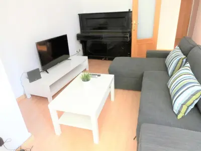 a living room with a couch and a piano at Total Valencia Mercat in Valencia