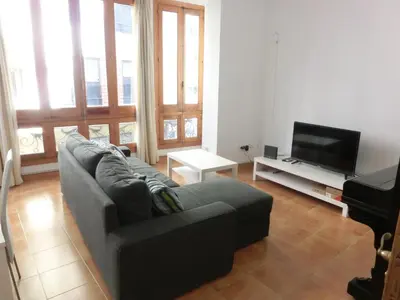 a living room with a couch and a flat screen tv at Total Valencia Mercat in Valencia