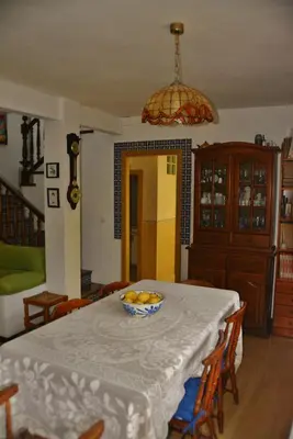 a dining room table with a bowl of fruit on it at Casa Las Violetas in Altura