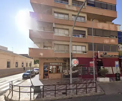 a building on the corner of a street at Rooms Avenida in Tavernes de Valldigna