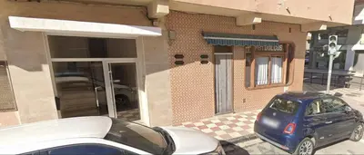 a car parked in front of a building at Rooms Avenida in Tavernes de Valldigna