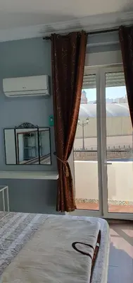 a bedroom with a bed and a large window at Habitación cerca del centro in Valencia