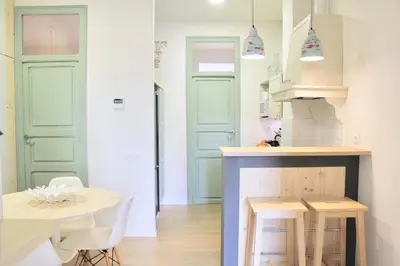 a kitchen with green doors and a table and chairs at Apartamento Con Vistas Espectaculares in Valencia