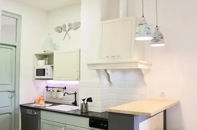 a kitchen with white walls and a black counter top at Apartamento Con Vistas Espectaculares in Valencia