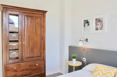 a bedroom with a wooden cabinet and a bed at Apartamento Con Vistas Espectaculares in Valencia