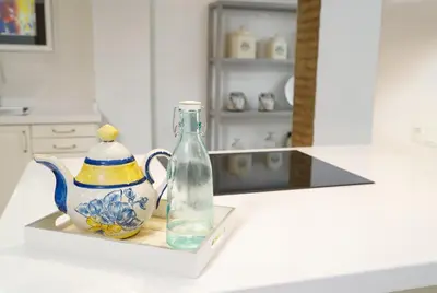 a glass bottle and a teapot sitting on a counter at Vivaldi Center City in Valencia