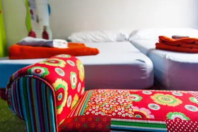 a room with a pile of mattresses and a couch at Feetup Home Backpackers Valencia in Valencia