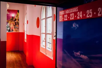 a room with red white and blue walls and a window at Feetup Home Backpackers Valencia in Valencia