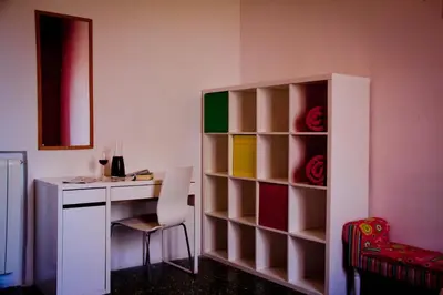 a room with a desk and a table with a chair at Feetup Home Backpackers Valencia in Valencia