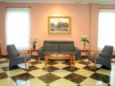 a living room with a couch and chairs and a table at Hotel Isabel in Almussafes