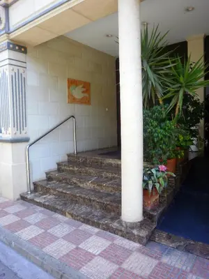 a set of stairs in a building with a column at Hotel Isabel in Almussafes
