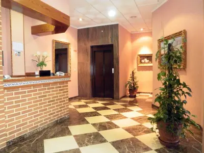 a lobby with a checkered floor and a door at Hotel Isabel in Almussafes