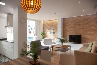 a living room with a couch and a tv at Casa Marcellino Valencia Centro in Valencia