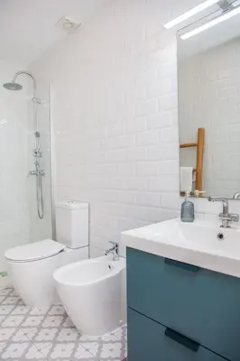 a bathroom with a sink and a toilet and a mirror at Casa Marcellino Valencia Centro in Valencia
