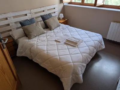 a bedroom with a large white bed with pillows at Hostal El Convent de Moncada in Moncada