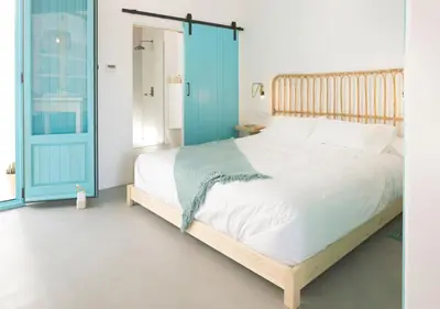 a bedroom with a bed and a blue door at Apartamentos La más Bonita in Valencia
