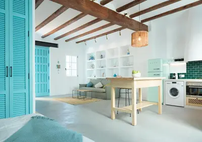 a kitchen and living room with a table and a couch at Apartamentos La más Bonita in Valencia
