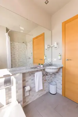 a bathroom with a sink and a mirror at Sky Touristic Attic in Valencia